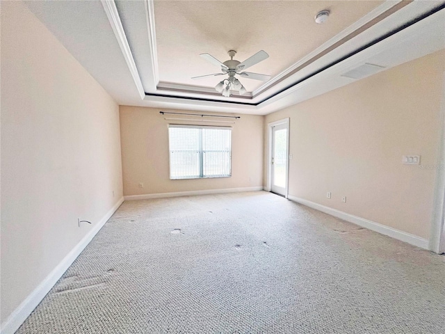 161 Frontier Dr, Palm Coast, FL 32137 - empty room with a raised ceiling, a ceiling fan, light carpet, baseboards, and crown molding