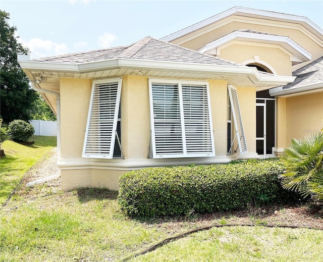 161 Frontier Dr, Palm Coast, FL 32137 - view of side of property featuring stucco siding and roof with shingles