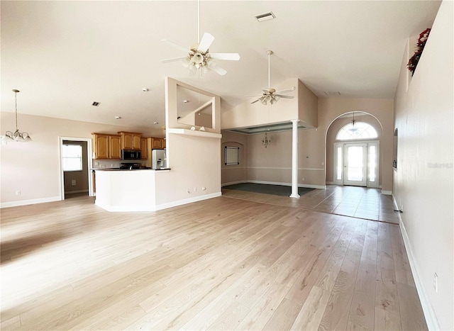 161 Frontier Dr, Palm Coast, FL 32137 - unfurnished living room with a ceiling fan, light wood-type flooring, high vaulted ceiling, and baseboards