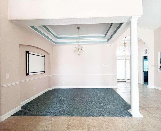161 Frontier Dr, Palm Coast, FL 32137 - tiled spare room with a tray ceiling, carpet flooring, ornamental molding, arched walkways, and baseboards