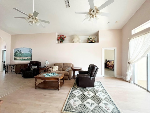 161 Frontier Dr, Palm Coast, FL 32137 - living area featuring ceiling fan, arched walkways, light wood-type flooring, and a high ceiling