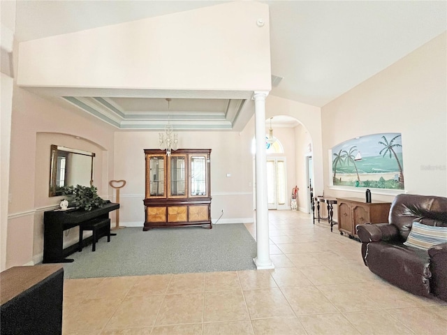 161 Frontier Dr, Palm Coast, FL 32137 - living area with arched walkways, light tile patterned flooring, light carpet, decorative columns, and baseboards