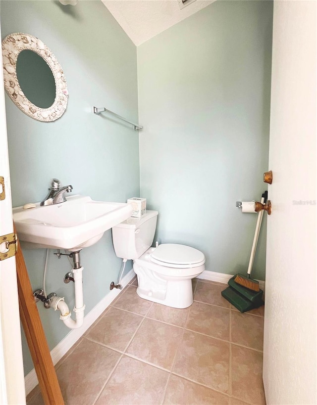 161 Frontier Dr, Palm Coast, FL 32137 - half bath featuring toilet, tile patterned floors, and baseboards