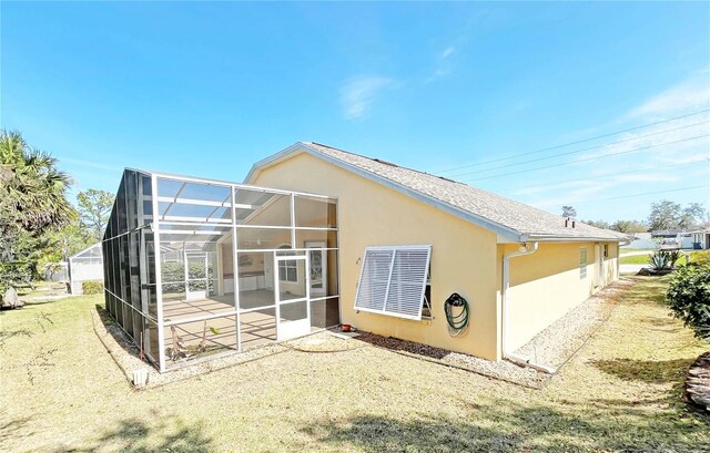 161 Frontier Dr, Palm Coast, FL 32137 - back of house with stucco siding, glass enclosure, and a patio