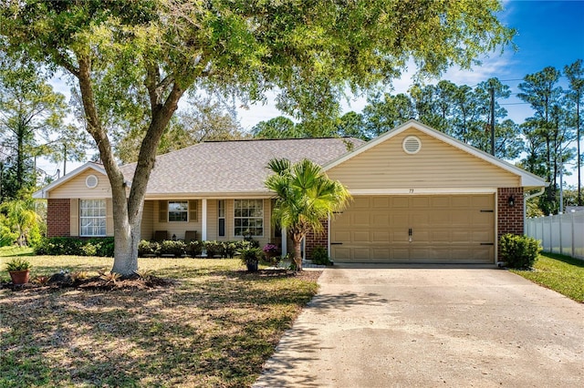 73 Royal Oak Dr, Palm Coast, FL 32164 - single story home with brick siding, fence, a garage, and concrete driveway