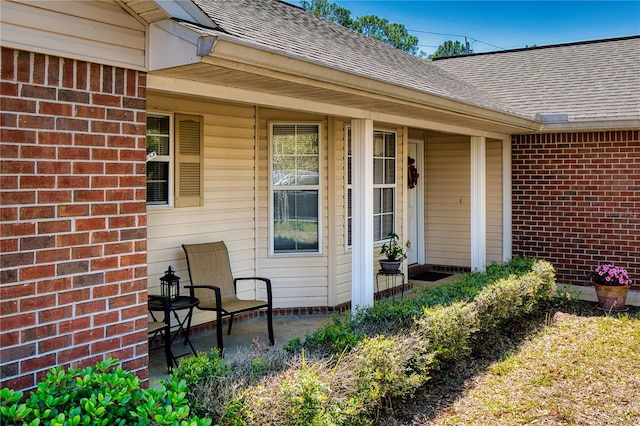 73 Royal Oak Dr, Palm Coast, FL 32164 - view of exterior entry featuring brick siding and roof with shingles