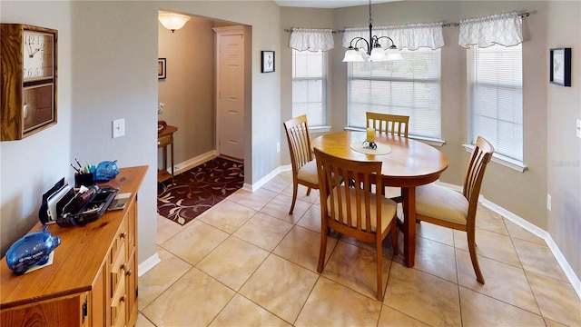 73 Royal Oak Dr, Palm Coast, FL 32164 - dining space with an inviting chandelier, light tile patterned floors, and baseboards