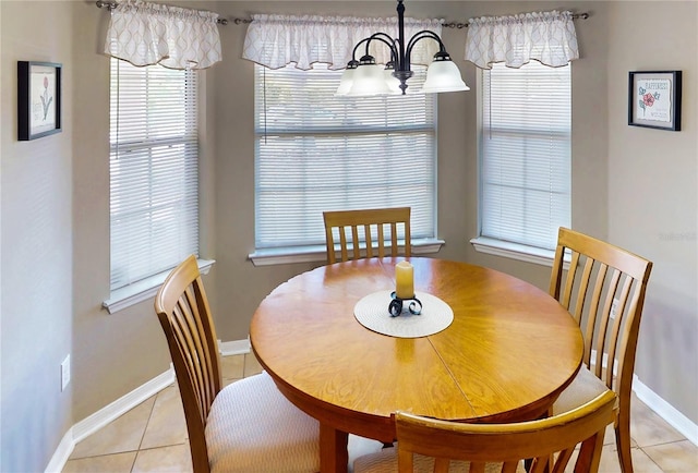 73 Royal Oak Dr, Palm Coast, FL 32164 - dining area featuring baseboards, an inviting chandelier, and light tile patterned floors