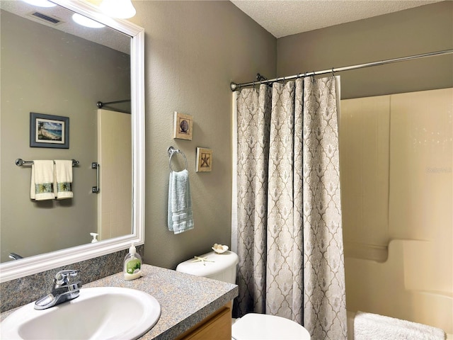 73 Royal Oak Dr, Palm Coast, FL 32164 - full bathroom with a shower with curtain, toilet, vanity, and a textured ceiling