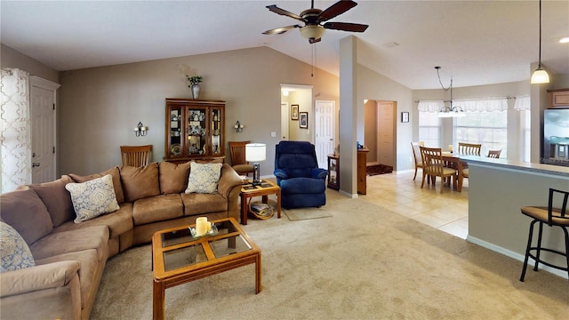 73 Royal Oak Dr, Palm Coast, FL 32164 - living room featuring lofted ceiling, light tile patterned floors, ceiling fan with notable chandelier, baseboards, and light carpet