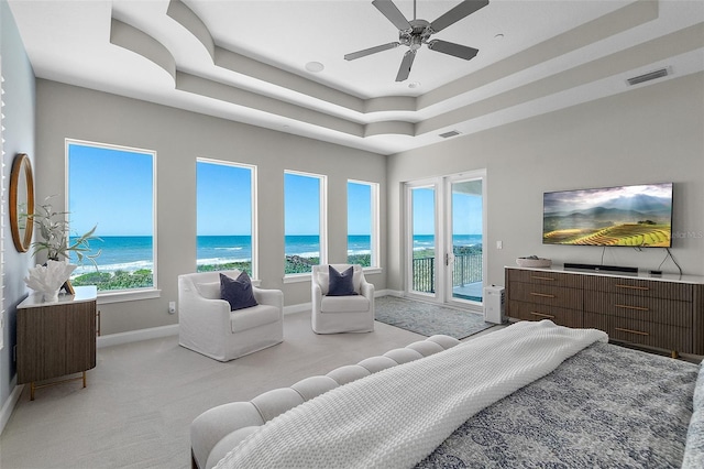 46 Ocean Ridge Blvd N, Palm Coast, FL 32137 - bedroom featuring access to exterior, light carpet, baseboards, and a tray ceiling