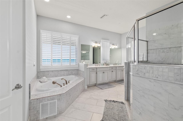 46 Ocean Ridge Blvd N, Palm Coast, FL 32137 - bathroom with vanity, a jetted tub, a stall shower, and marble finish floors