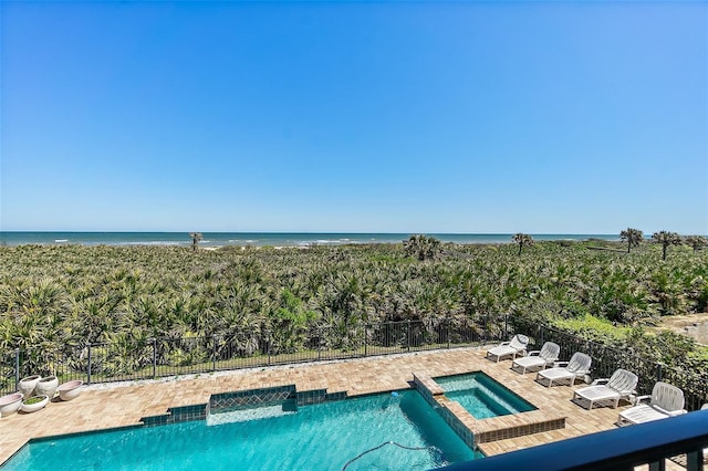 46 Ocean Ridge Blvd N, Palm Coast, FL 32137 - view of swimming pool featuring a pool with connected hot tub, a water view, and a patio area