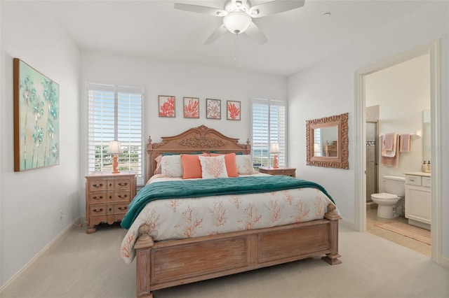 46 Ocean Ridge Blvd N, Palm Coast, FL 32137 - bedroom featuring light colored carpet, ensuite bath, baseboards, and a ceiling fan