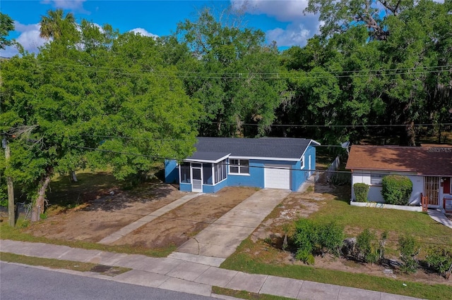 906 Magnolia Ave, Daytona Beach, FL 32114 - view of front of home featuring driveway, a garage, roof with shingles, and a front yard