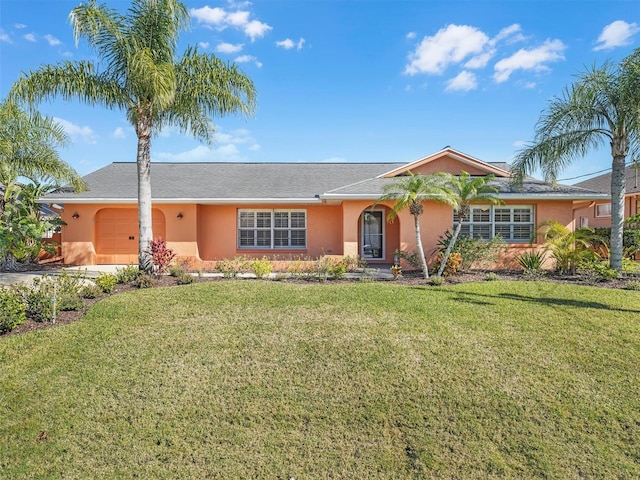 single story home featuring a garage, stucco siding, and a front yard