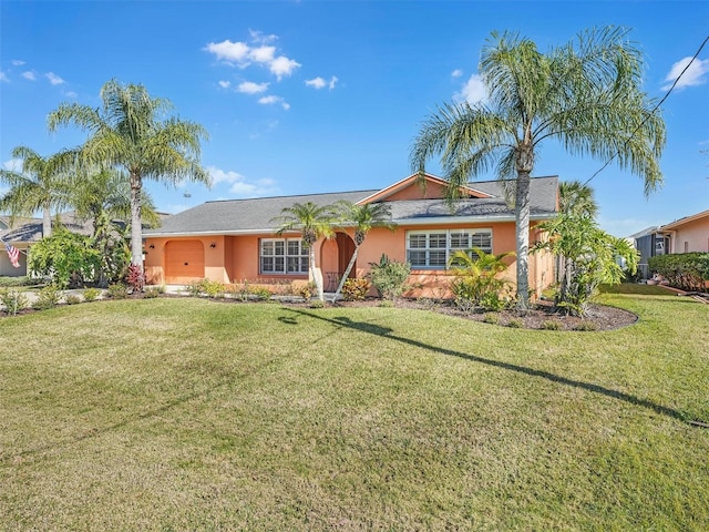 ranch-style house featuring stucco siding, an attached garage, and a front lawn