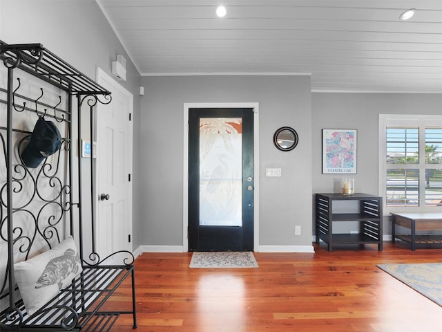 entrance foyer featuring baseboards, ornamental molding, recessed lighting, and wood finished floors