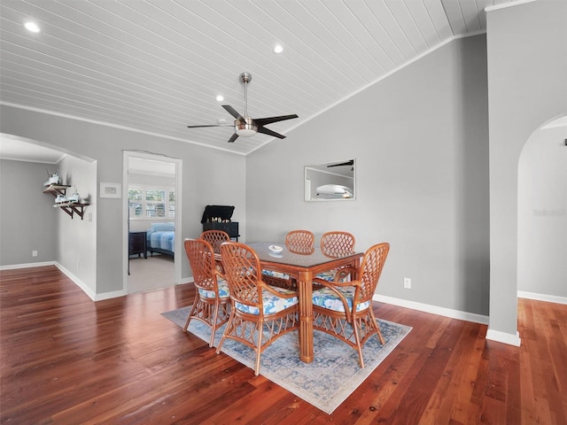 dining room featuring arched walkways, vaulted ceiling, and wood ceiling