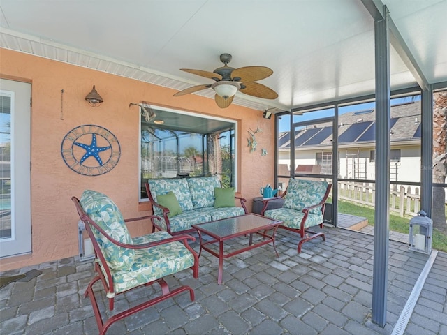 sunroom / solarium featuring ceiling fan and outdoor lounge area