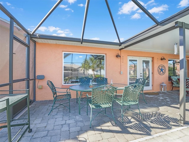 view of patio featuring french doors and a lanai