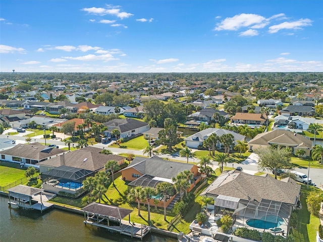 drone / aerial view with a water view and a residential view