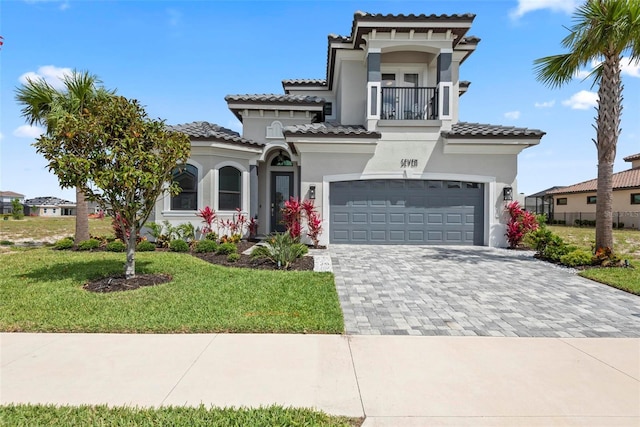 7 Menorca Way, Palm Coast, FL 32137 - mediterranean / spanish house with a front yard, a garage, decorative driveway, a balcony, and stucco siding