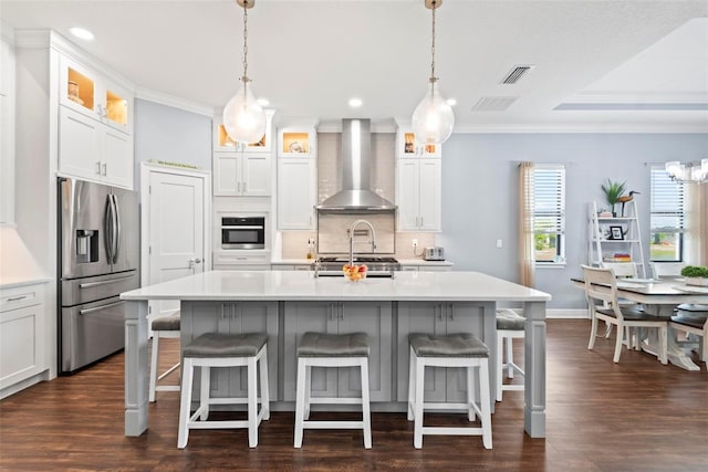 7 Menorca Way, Palm Coast, FL 32137 - kitchen featuring crown molding, light countertops, wall chimney exhaust hood, stainless steel appliances, and tasteful backsplash