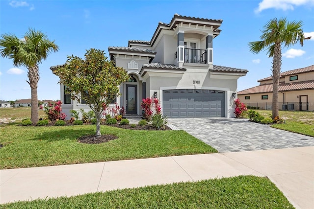 7 Menorca Way, Palm Coast, FL 32137 - mediterranean / spanish-style home featuring a front yard, a garage, decorative driveway, a balcony, and stucco siding