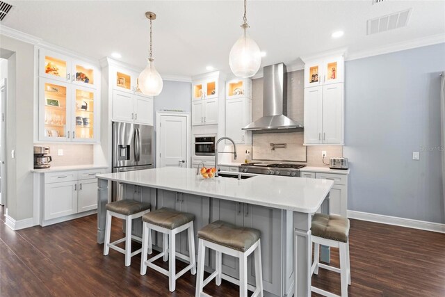 7 Menorca Way, Palm Coast, FL 32137 - kitchen featuring wall chimney range hood, visible vents, a sink, baseboards, and stainless steel appliances