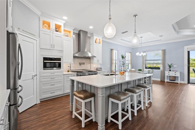 7 Menorca Way, Palm Coast, FL 32137 - kitchen with dark wood-type flooring, visible vents, wall chimney range hood, and stainless steel appliances