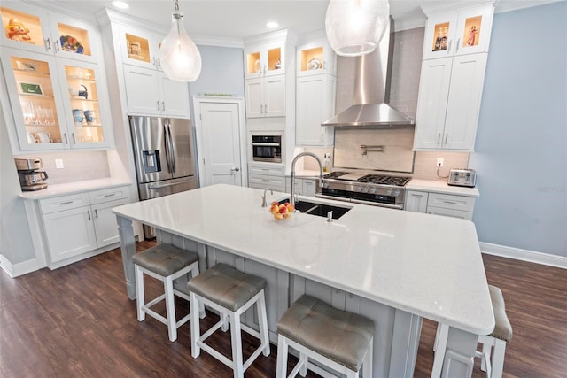 7 Menorca Way, Palm Coast, FL 32137 - kitchen featuring wall chimney range hood, a sink, dark wood finished floors, stainless steel appliances, and baseboards