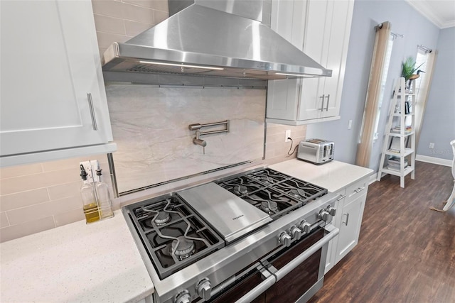 7 Menorca Way, Palm Coast, FL 32137 - kitchen with range with two ovens, tasteful backsplash, extractor fan, dark wood-style floors, and white cabinetry