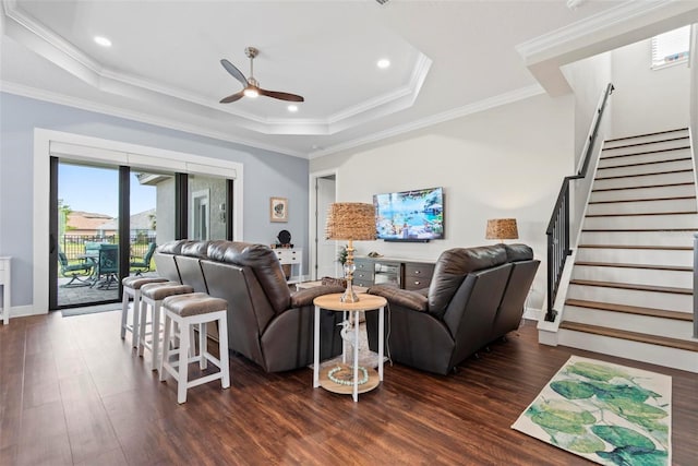 7 Menorca Way, Palm Coast, FL 32137 - living area with a ceiling fan, wood finished floors, a raised ceiling, ornamental molding, and stairs