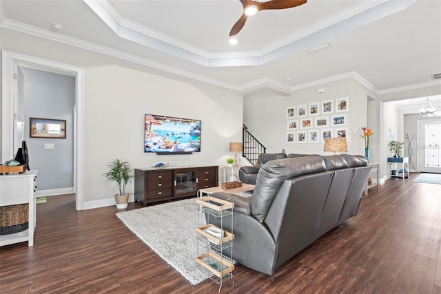 7 Menorca Way, Palm Coast, FL 32137 - living area with a raised ceiling, dark wood-style flooring, ceiling fan with notable chandelier, and stairway