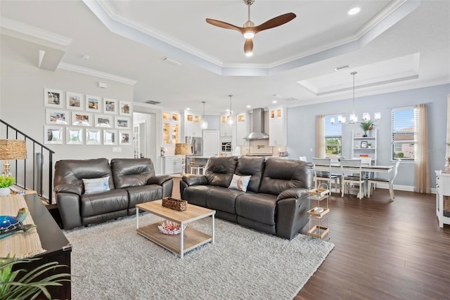 7 Menorca Way, Palm Coast, FL 32137 - living area with crown molding, dark wood finished floors, a raised ceiling, ceiling fan with notable chandelier, and recessed lighting
