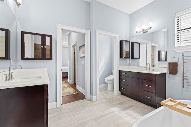 7 Menorca Way, Palm Coast, FL 32137 - full bathroom with a sink, a freestanding bath, two vanities, and toilet