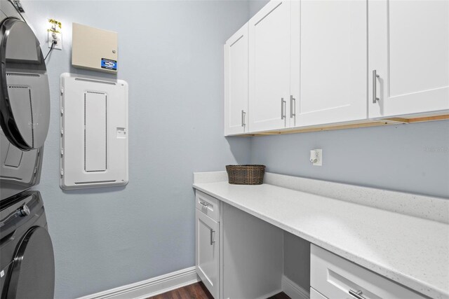 7 Menorca Way, Palm Coast, FL 32137 - washroom with baseboards, dark wood-type flooring, cabinet space, and stacked washer / dryer