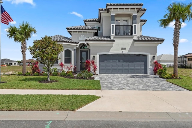 7 Menorca Way, Palm Coast, FL 32137 - mediterranean / spanish-style home with a garage, a tiled roof, stucco siding, and a balcony