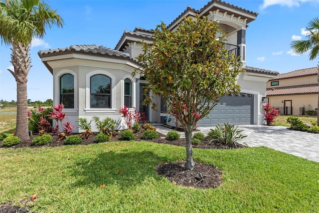 7 Menorca Way, Palm Coast, FL 32137 - mediterranean / spanish house with a tile roof, decorative driveway, a balcony, a front lawn, and stucco siding