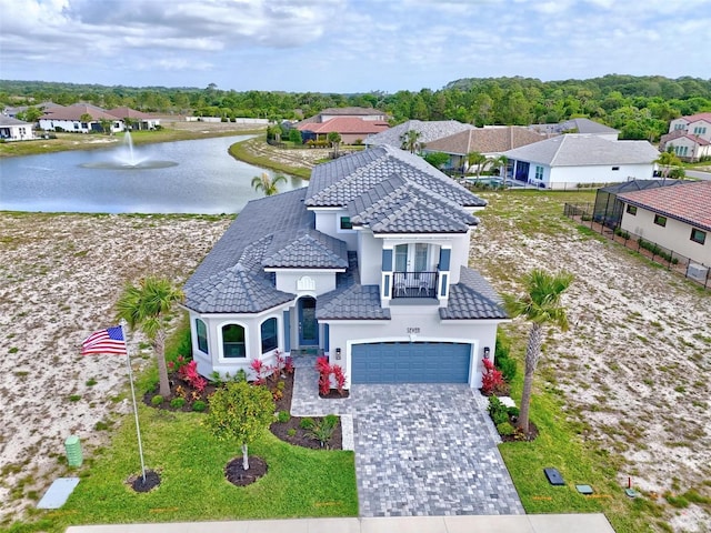 7 Menorca Way, Palm Coast, FL 32137 - view of front of property with a garage, a water view, decorative driveway, a balcony, and a tiled roof