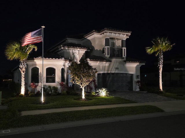7 Menorca Way, Palm Coast, FL 32137 - mediterranean / spanish house featuring a garage, a balcony, stucco siding, a tiled roof, and driveway