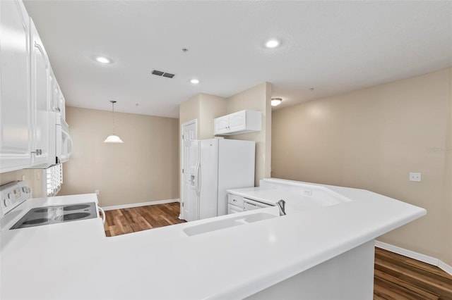 500 Canopy Walk Ln Unit 515, Palm Coast, FL 32137 - kitchen featuring white appliances, dark wood-style flooring, white cabinets, decorative light fixtures, and recessed lighting