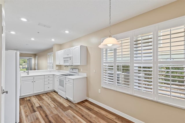 500 Canopy Walk Ln Unit 515, Palm Coast, FL 32137 - kitchen with white appliances, recessed lighting, light wood-style flooring, white cabinetry, and pendant lighting