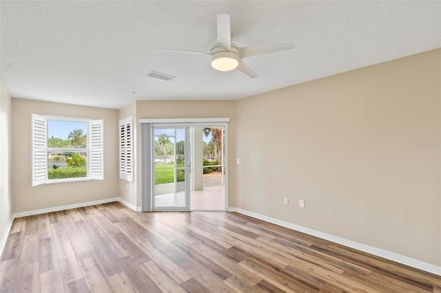 500 Canopy Walk Ln Unit 515, Palm Coast, FL 32137 - empty room featuring healthy amount of natural light, wood finished floors, and a ceiling fan