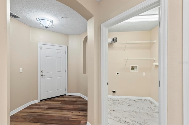 500 Canopy Walk Ln Unit 515, Palm Coast, FL 32137 - foyer with arched walkways, a textured ceiling, and dark wood-style floors