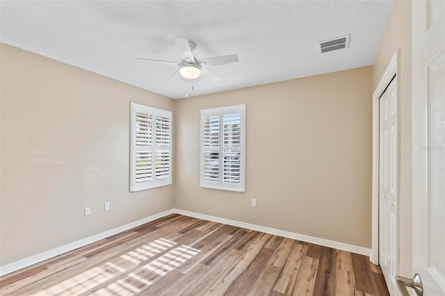 500 Canopy Walk Ln Unit 515, Palm Coast, FL 32137 - unfurnished bedroom with wood finished floors, a closet, a textured ceiling, and ceiling fan