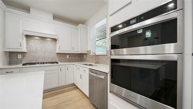314 Red Barn Rd, Saint Augustine, FL 32092 - kitchen featuring light countertops, tasteful backsplash, appliances with stainless steel finishes, a sink, and light wood-type flooring