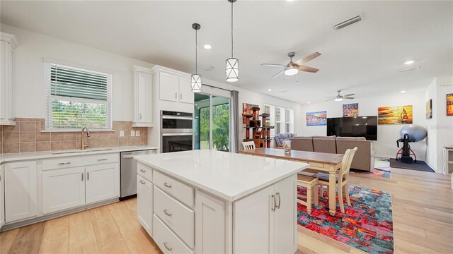 314 Red Barn Rd, Saint Augustine, FL 32092 - kitchen with visible vents, a ceiling fan, tasteful backsplash, appliances with stainless steel finishes, and a sink