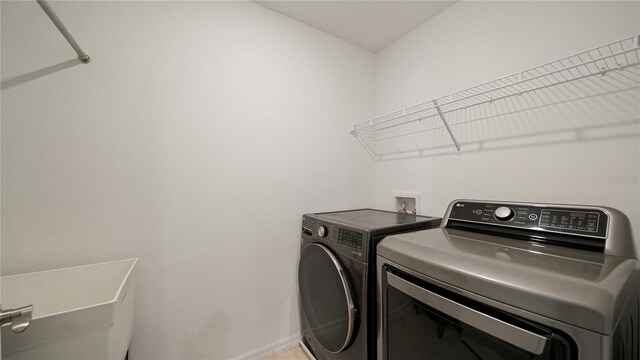 314 Red Barn Rd, Saint Augustine, FL 32092 - clothes washing area featuring washing machine and clothes dryer, baseboards, laundry area, and a sink